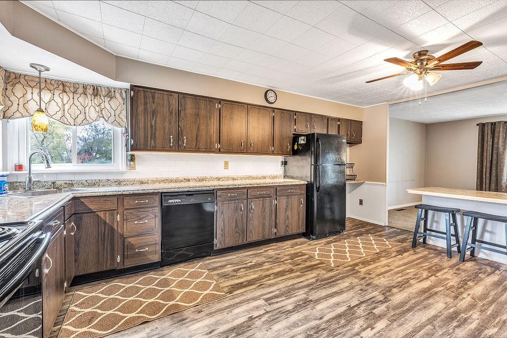 110 Maple Drive Beaver, PA 15009 - Photo 7 of 23 a kitchen with stainless steel appliances granite countertop a sink cabinets and wooden floor