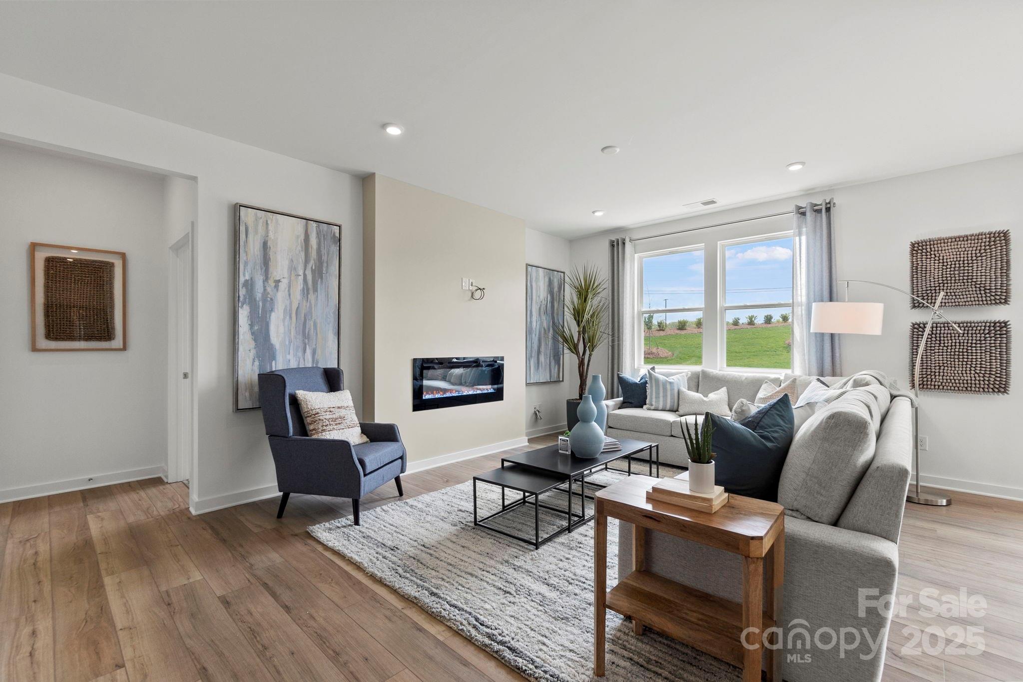 2573 Blue Sky Mdws Drive Monroe, NC 28110 - Photo 13 of 45 a living room with furniture and a fireplace