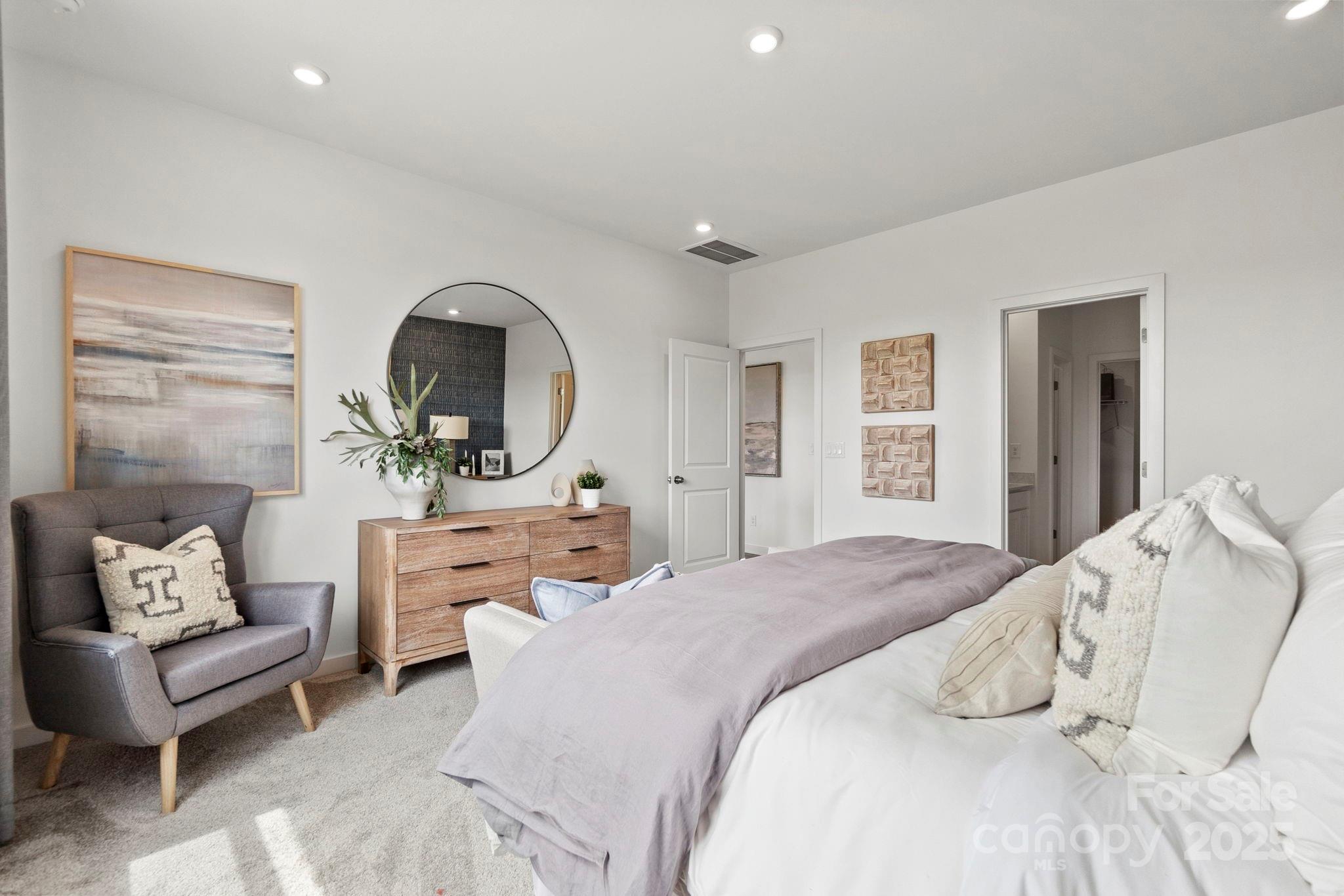 2573 Blue Sky Mdws Drive Monroe, NC 28110 - Photo 17 of 45 a bedroom with a large bed couch and a window