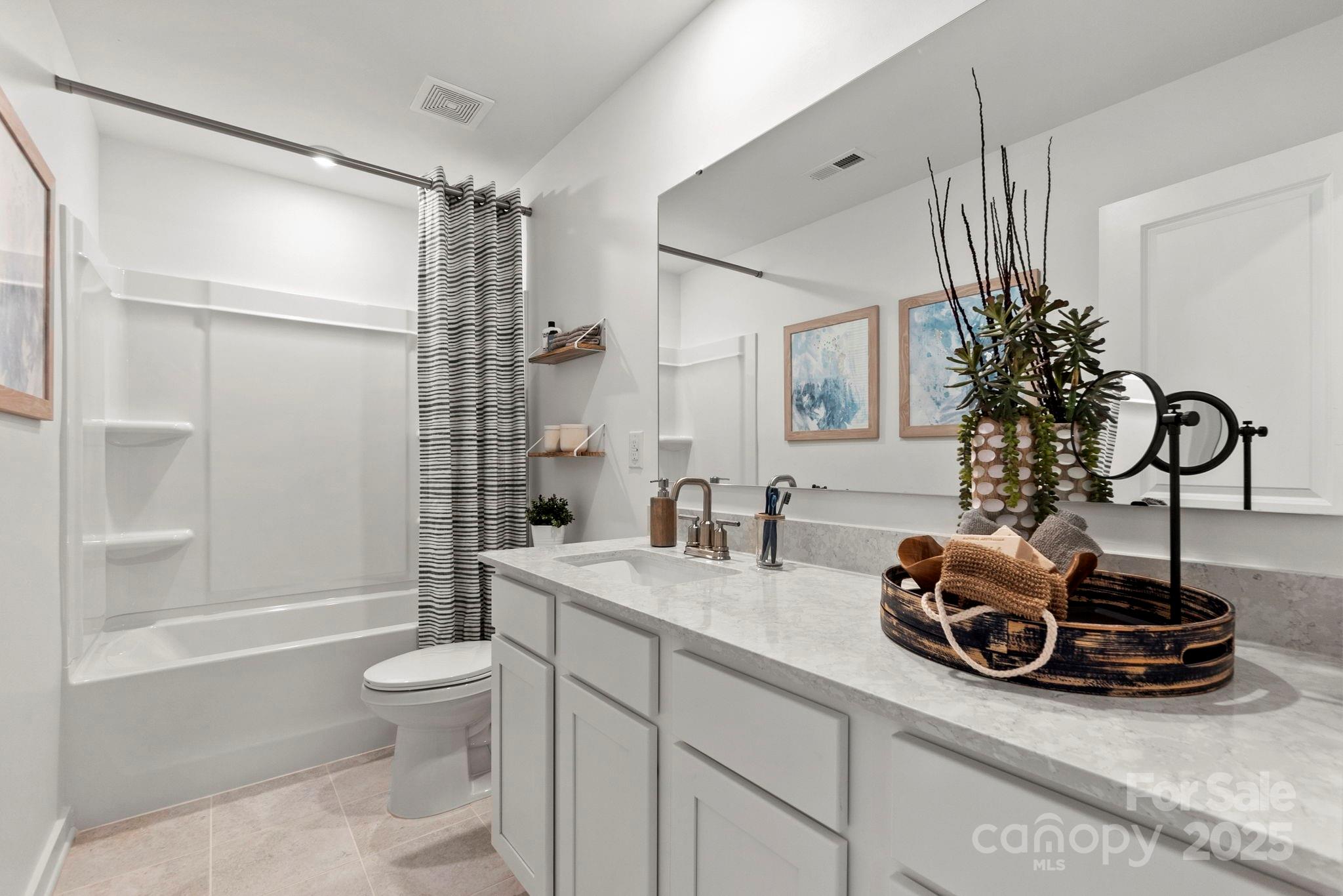 2573 Blue Sky Mdws Drive Monroe, NC 28110 - Photo 25 of 45 a bathroom with a sink a toilet and a large mirror