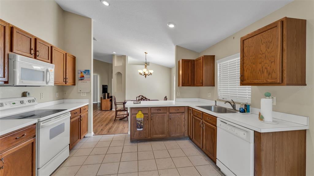 2729 Pankaw Lane Valrico, FL 33596 - Photo 12 of 41 a large kitchen with a sink and cabinets