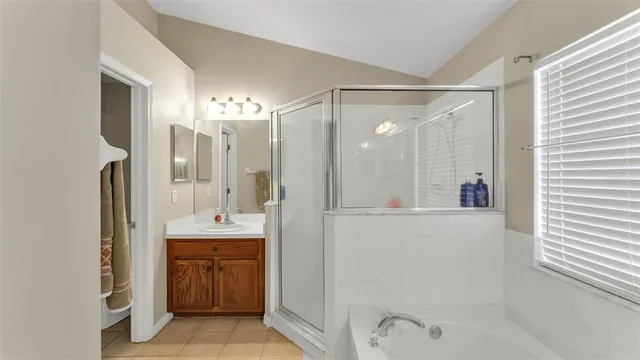 a bathroom with a shower sink and mirror