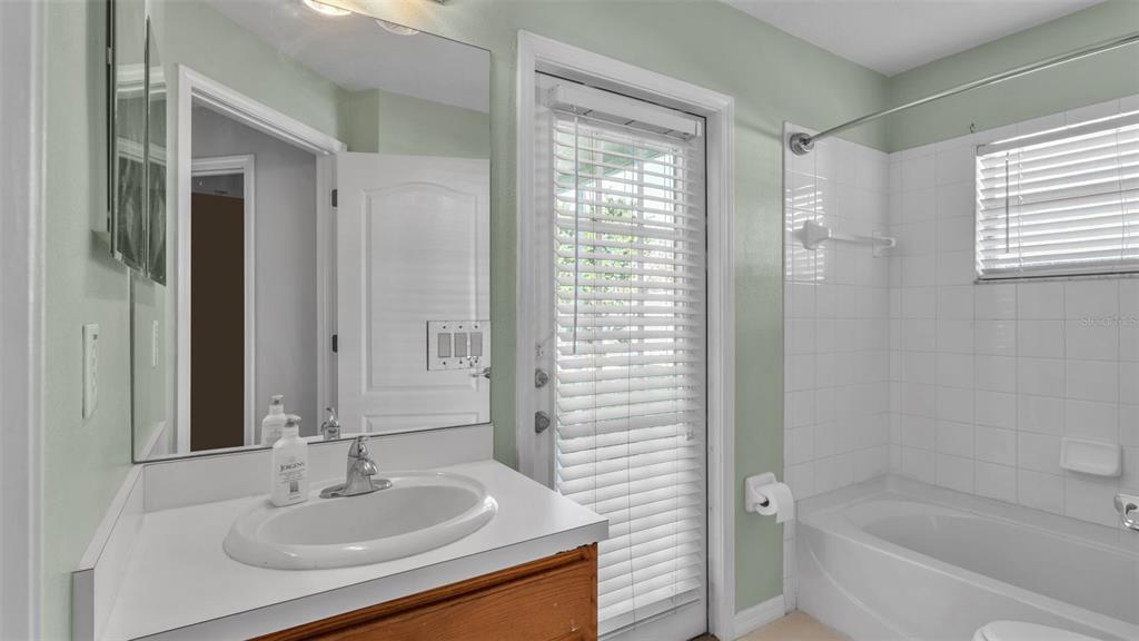 2729 Pankaw Lane Valrico, FL 33596 - Photo 19 of 41 a bathroom with a granite countertop sink a mirror and a bathtub