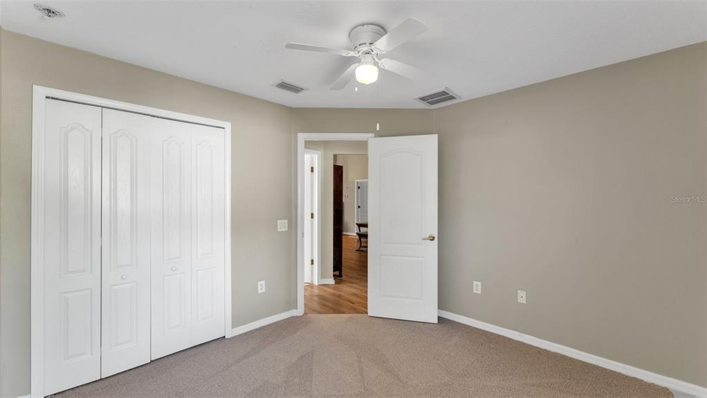 2729 Pankaw Lane Valrico, FL 33596 - Photo 21 of 41 an empty room with closet and a ceiling fan