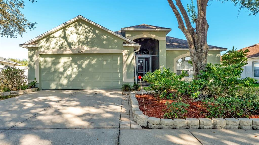 2729 Pankaw Lane Valrico, FL 33596 - Photo 37 of 41 a front view of a house with garden