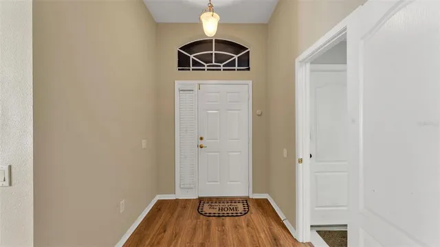 a view of a room with wooden floor and a sink
