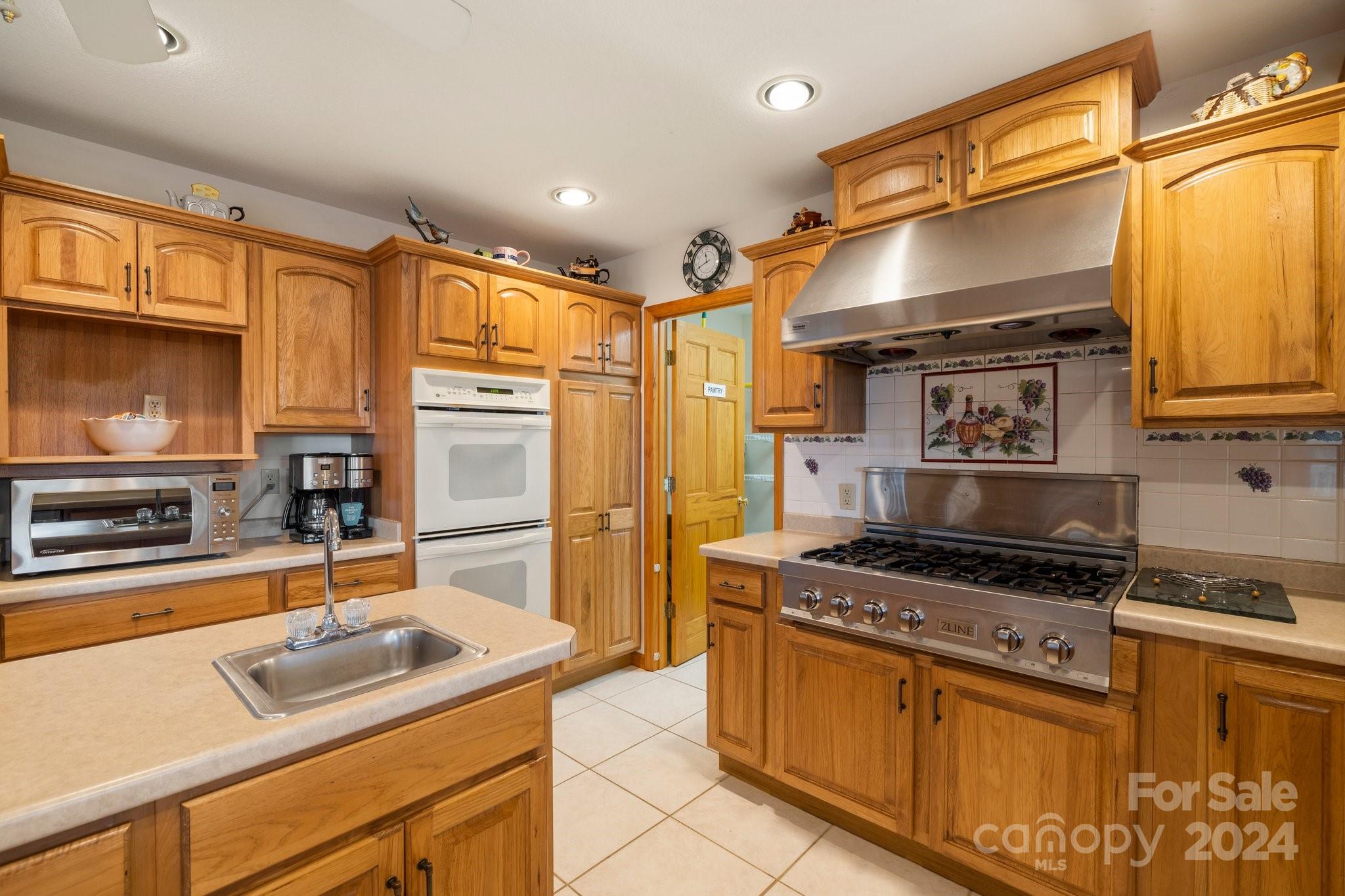 425 Turkey Run Bryson City, NC 28713 - Photo 11 of 47 a kitchen with stainless steel appliances granite countertop a sink stove and refrigerator