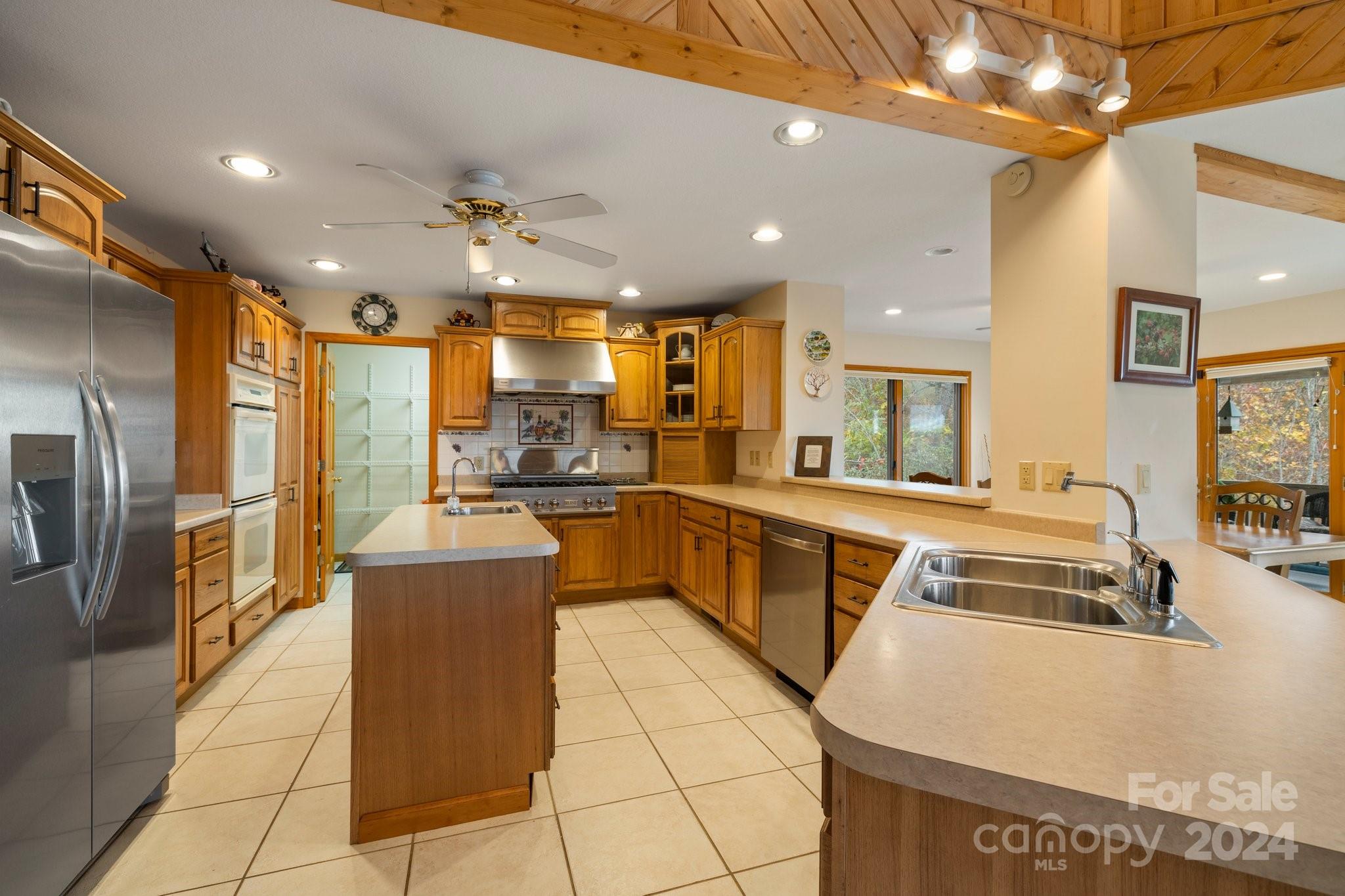 425 Turkey Run Bryson City, NC 28713 - Photo 12 of 47 a kitchen with stainless steel appliances granite countertop a sink and a refrigerator