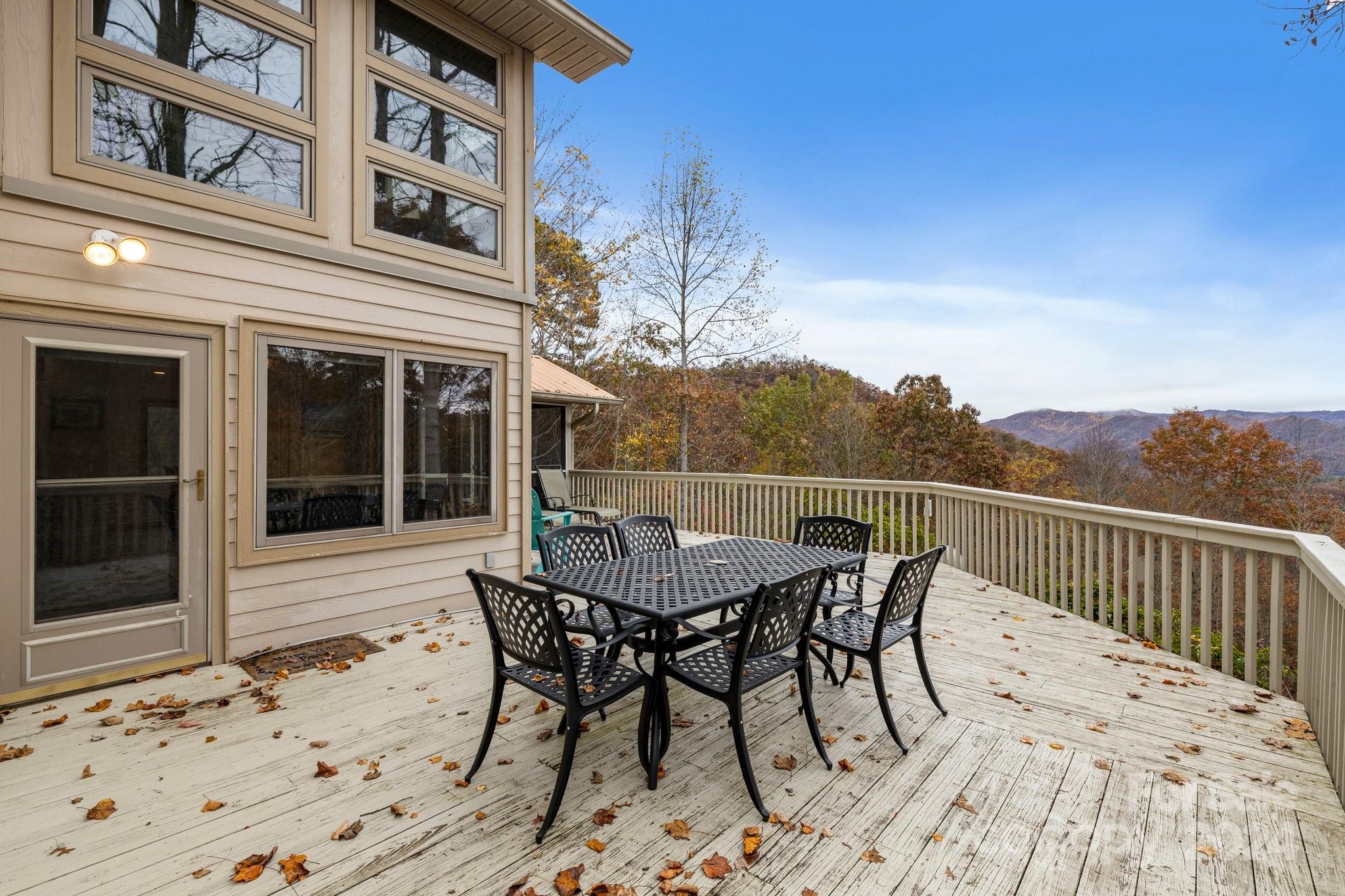 425 Turkey Run Bryson City, NC 28713 - Photo 23 of 47 a view of a roof deck with table and chairs and wooden floor
