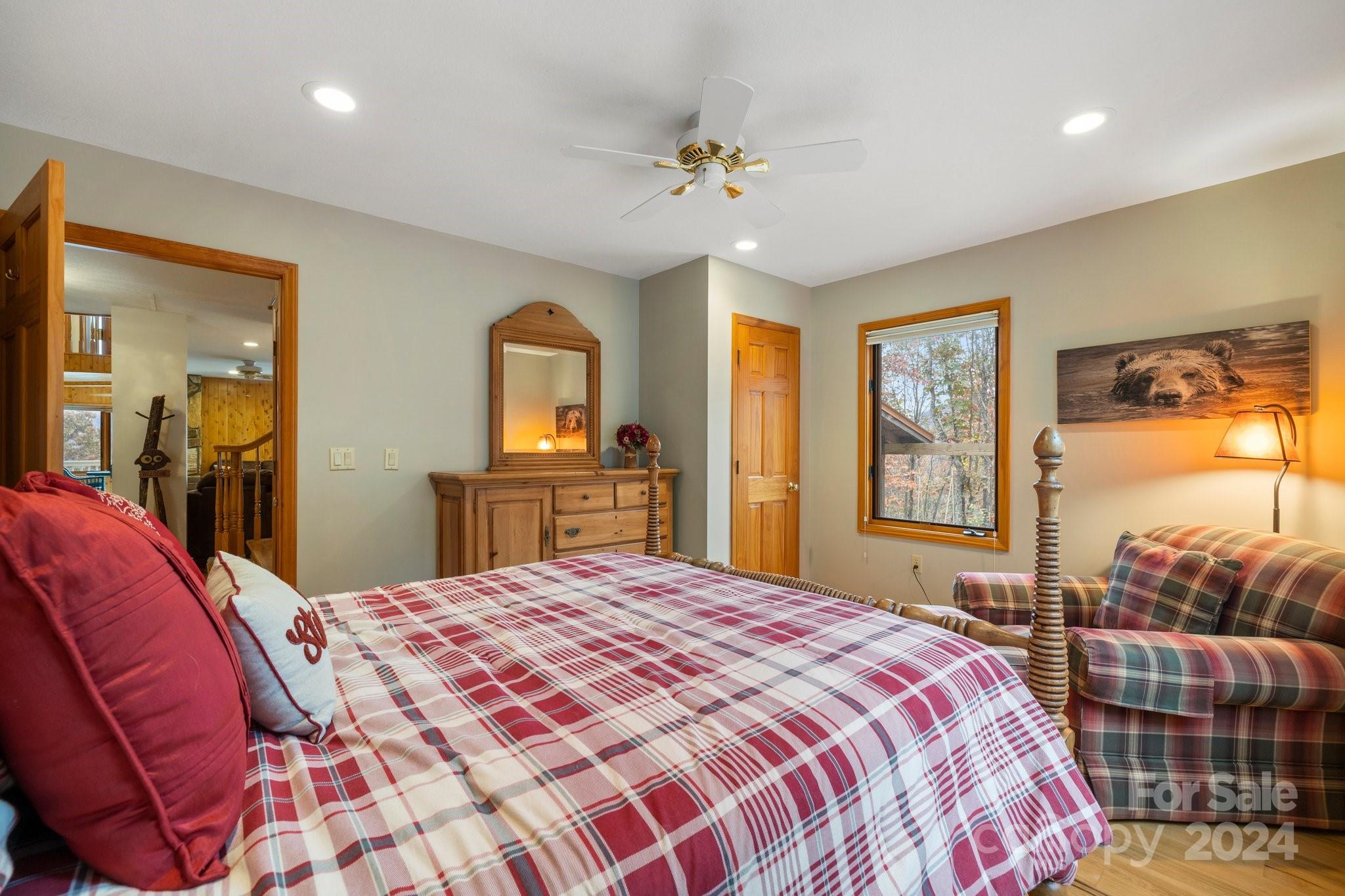 425 Turkey Run Bryson City, NC 28713 - Photo 26 of 47 a bedroom with a large bed and a chandelier