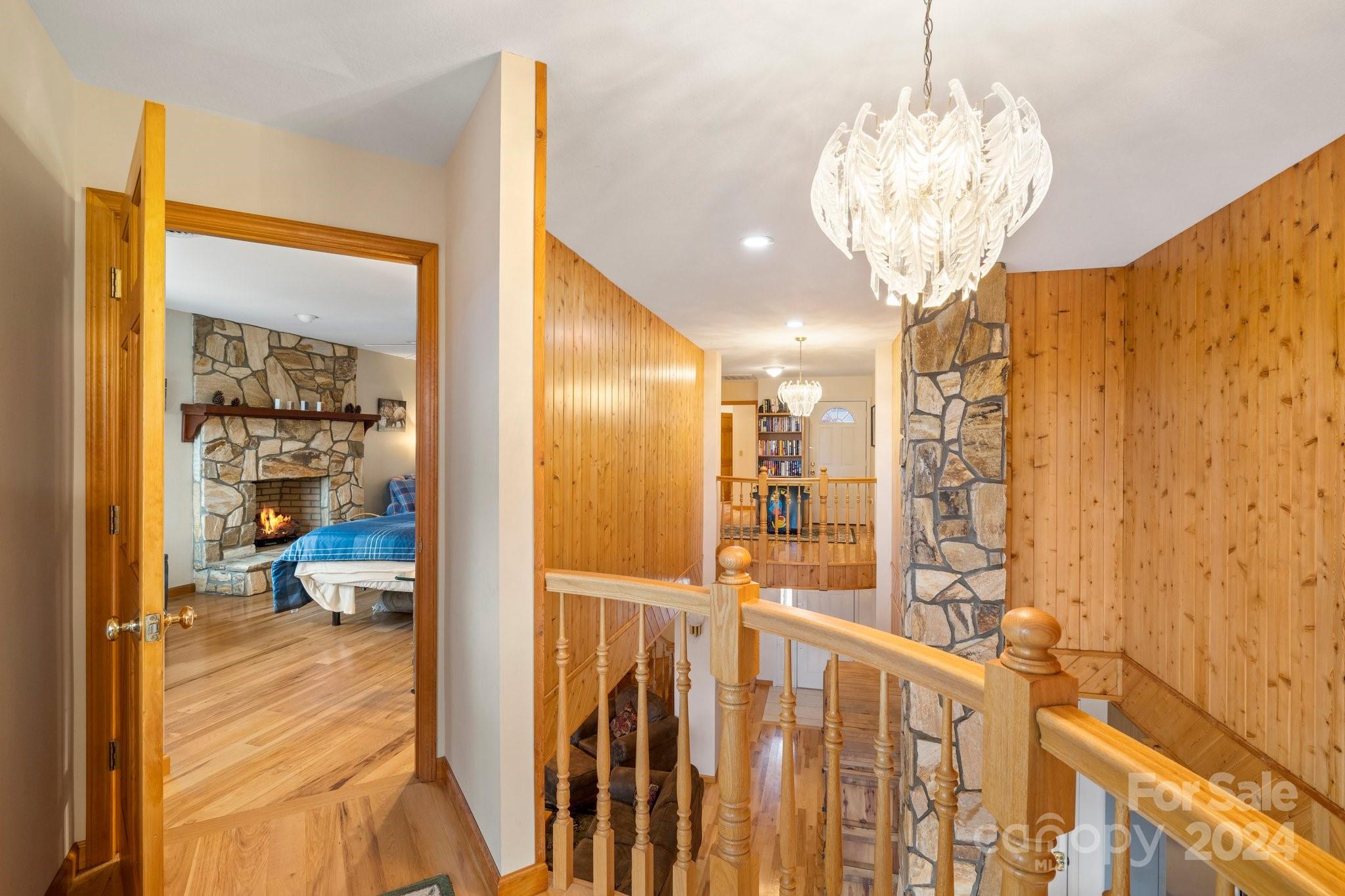425 Turkey Run Bryson City, NC 28713 - Photo 29 of 47 a view of a hallway with wooden floor and chandelier