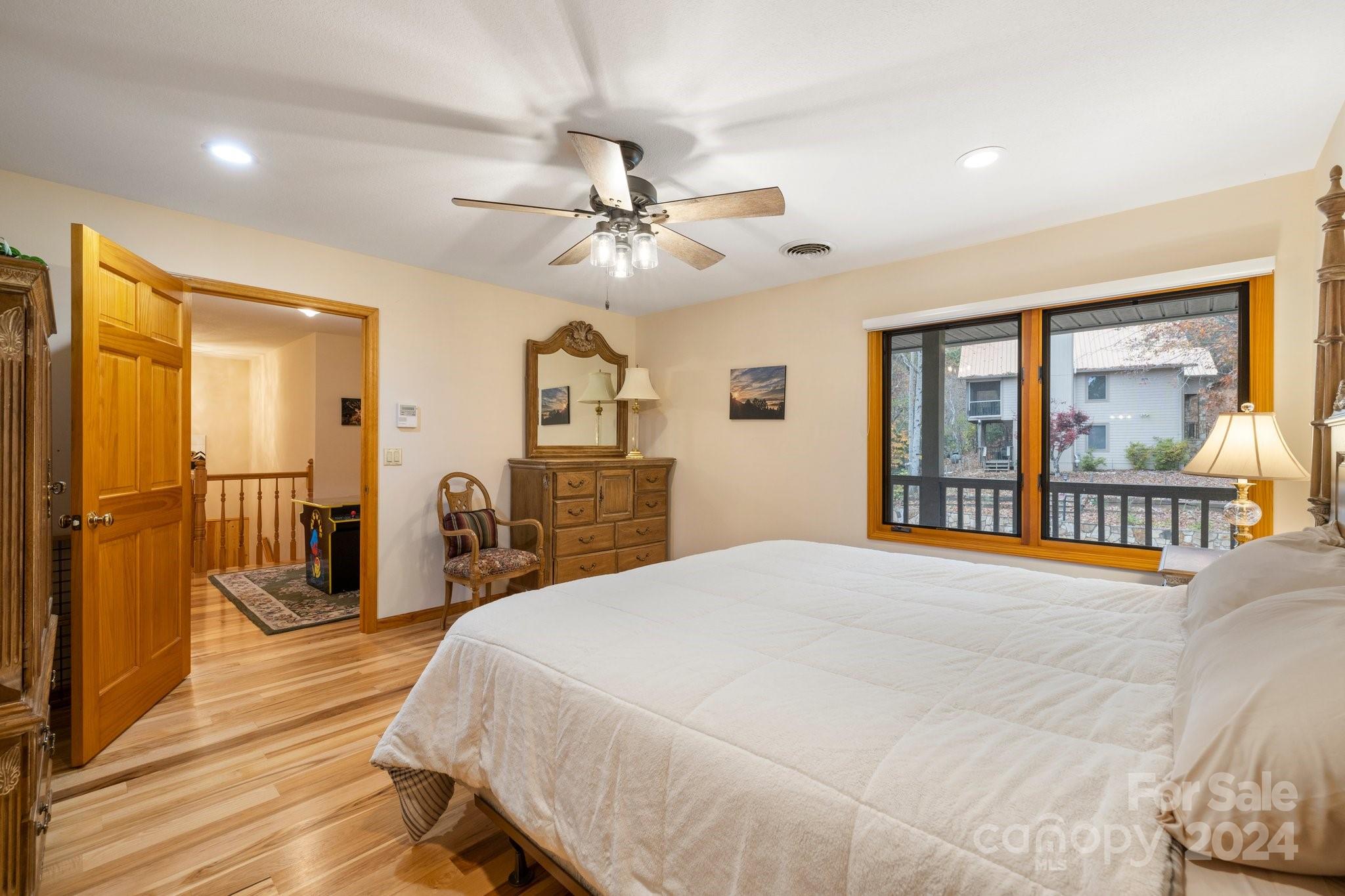 425 Turkey Run Bryson City, NC 28713 - Photo 39 of 47 a bedroom with a large bed and a chandelier
