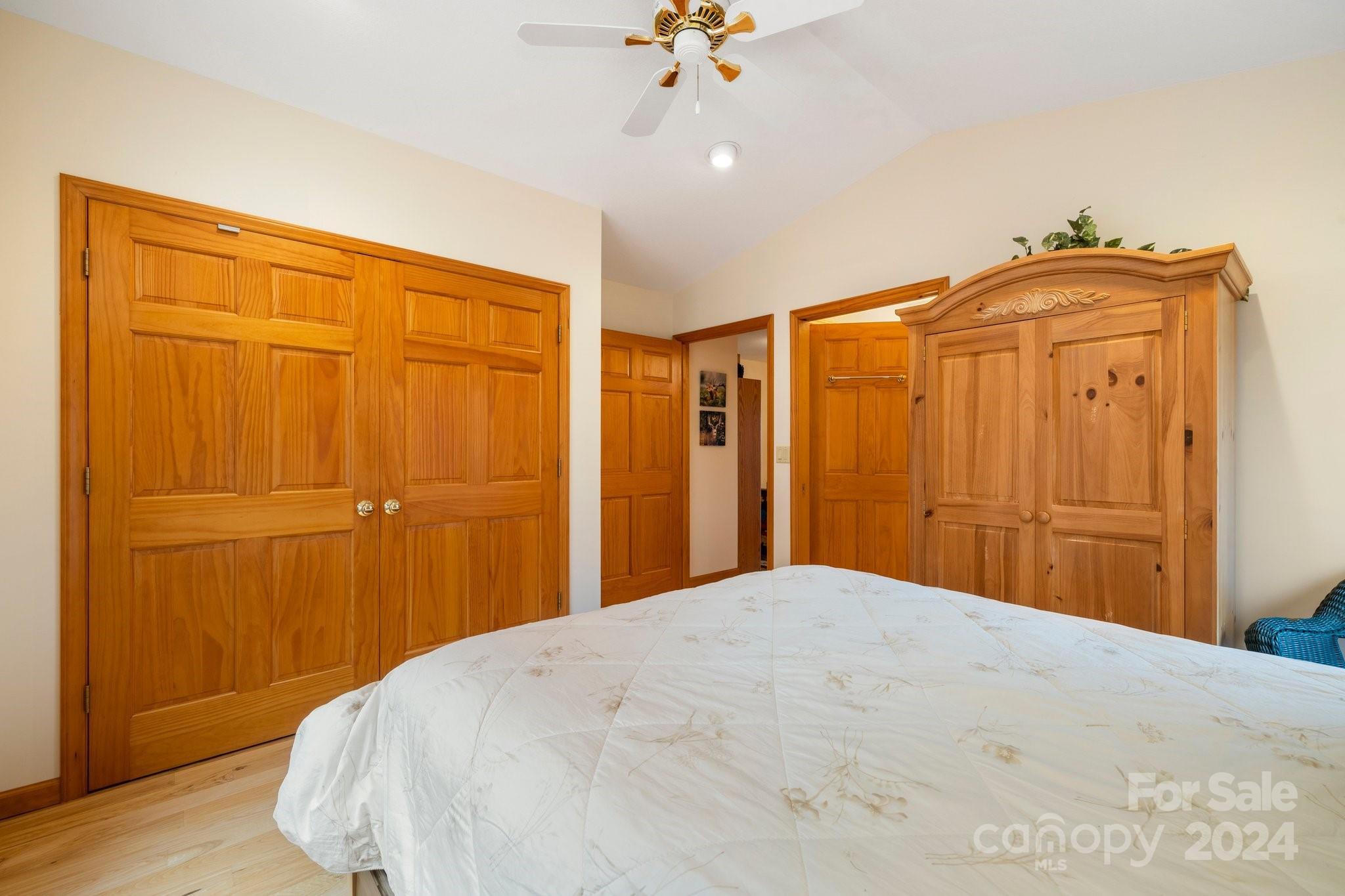 425 Turkey Run Bryson City, NC 28713 - Photo 42 of 47 a bedroom with a bed and a chandelier