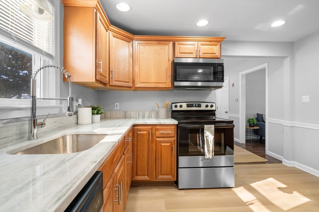 98 West Street Georgetown, MA 01833 - Photo 13 of 39 a kitchen with a stove and a microwave