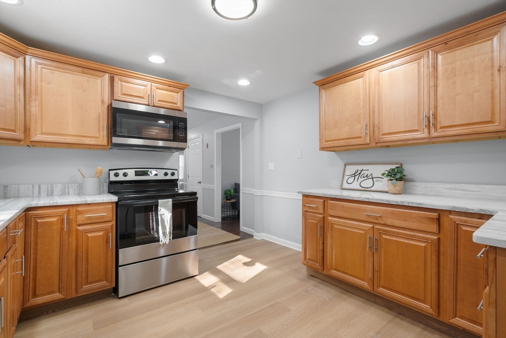 98 West Street Georgetown, MA 01833 - Photo 14 of 39 a kitchen with stainless steel appliances granite countertop a stove a sink and a microwave