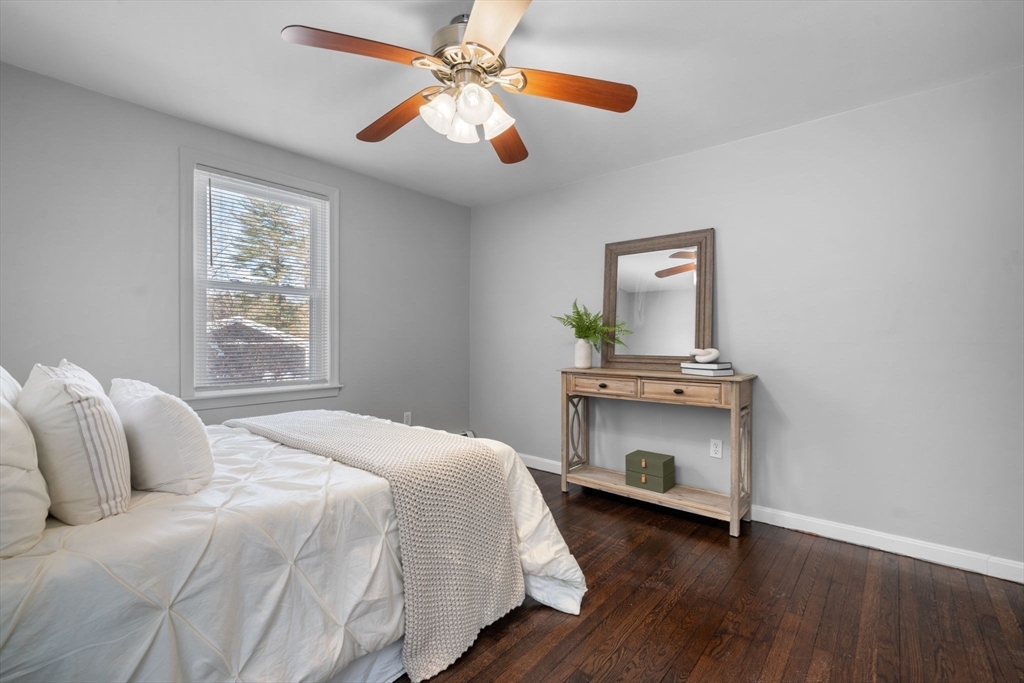98 West Street Georgetown, MA 01833 - Photo 15 of 39 a bedroom with a bed and a fireplace