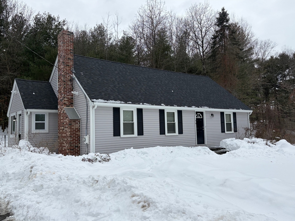 98 West Street Georgetown, MA 01833 - Photo 2 of 39 a front view of a house with a yard covered in snow