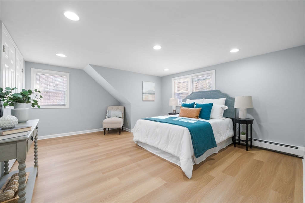 98 West Street Georgetown, MA 01833 - Photo 28 of 39 a bedroom with bed and a potted plant