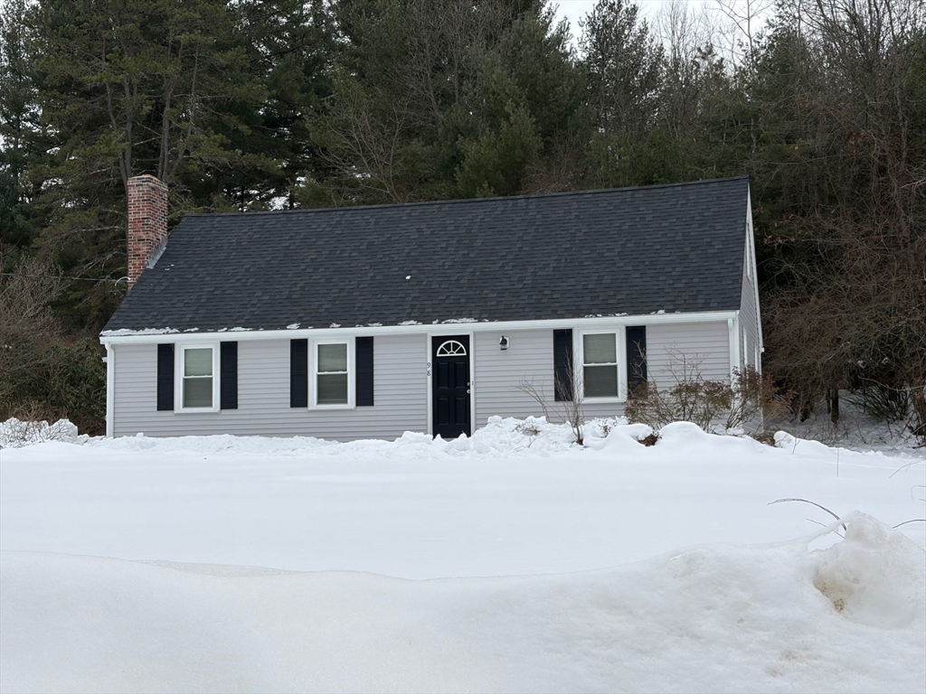98 West Street Georgetown, MA 01833 - Photo 3 of 39 a front view of house with yard covered in trees