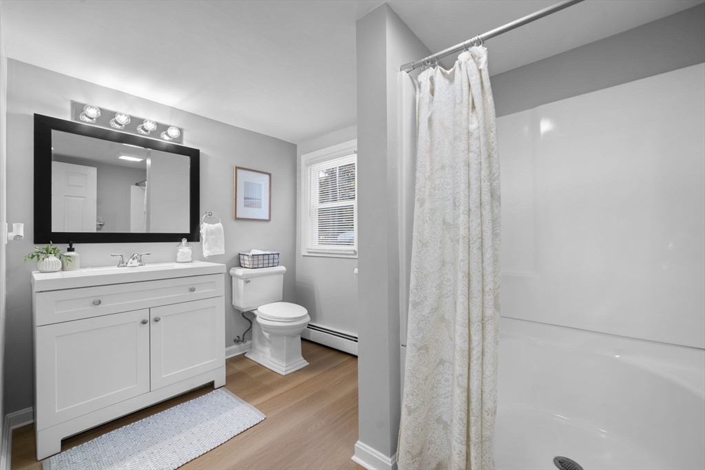 98 West Street Georgetown, MA 01833 - Photo 31 of 39 a bathroom with a toilet a sink and mirror