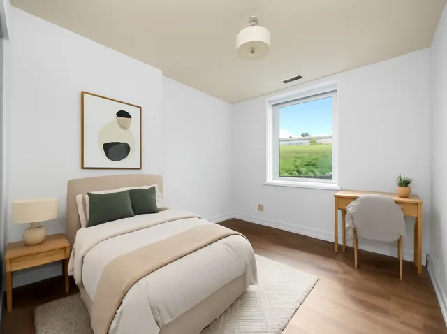 a bedroom with a bed and a desk