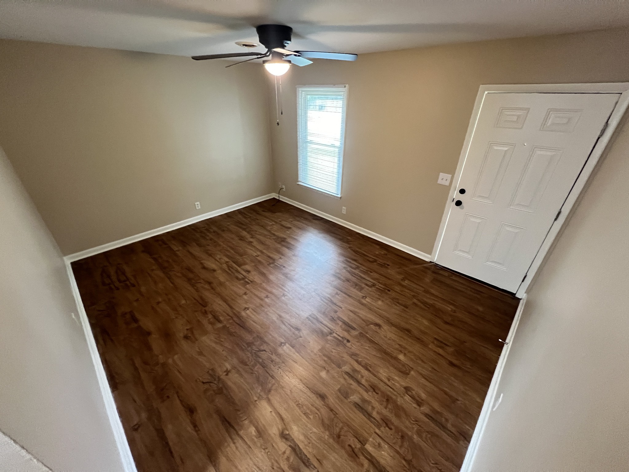 707 Riviera Drive, Unit A Murfreesboro, TN 37130 - Photo 2 of 9 an empty room with wooden floor fan and windows