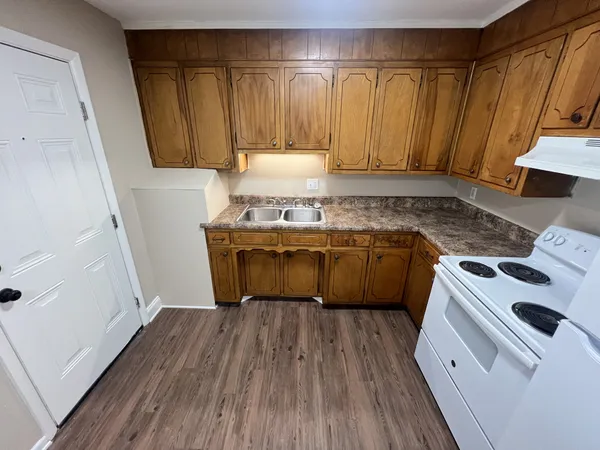 a kitchen with a stove a sink and a refrigerator