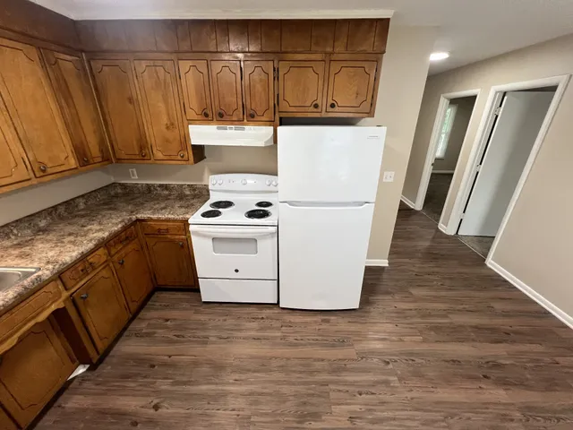 a kitchen with wooden cabinets and a stove top oven