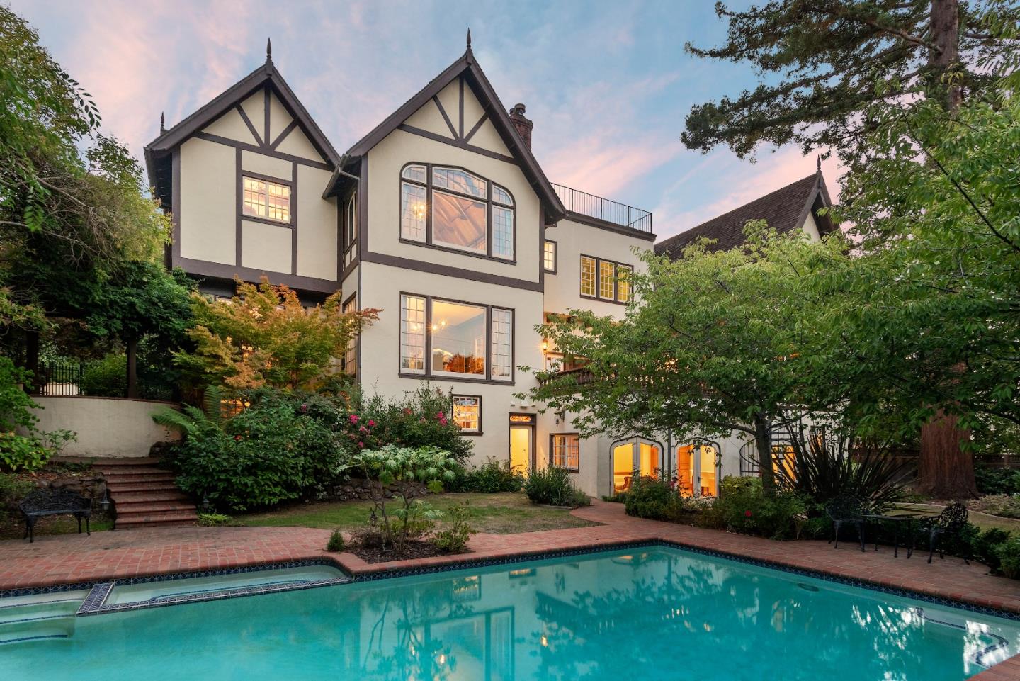 446 El Arroyo Road Hillsborough, CA 94010 - Photo 1 of 32 a front view of a house with a yard and garage