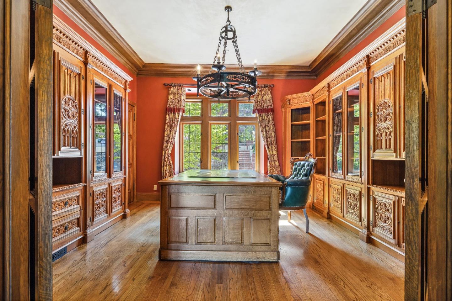 446 El Arroyo Road Hillsborough, CA 94010 - Photo 15 of 32 a dining room with wooden floor a chandelier a glass table and chairs