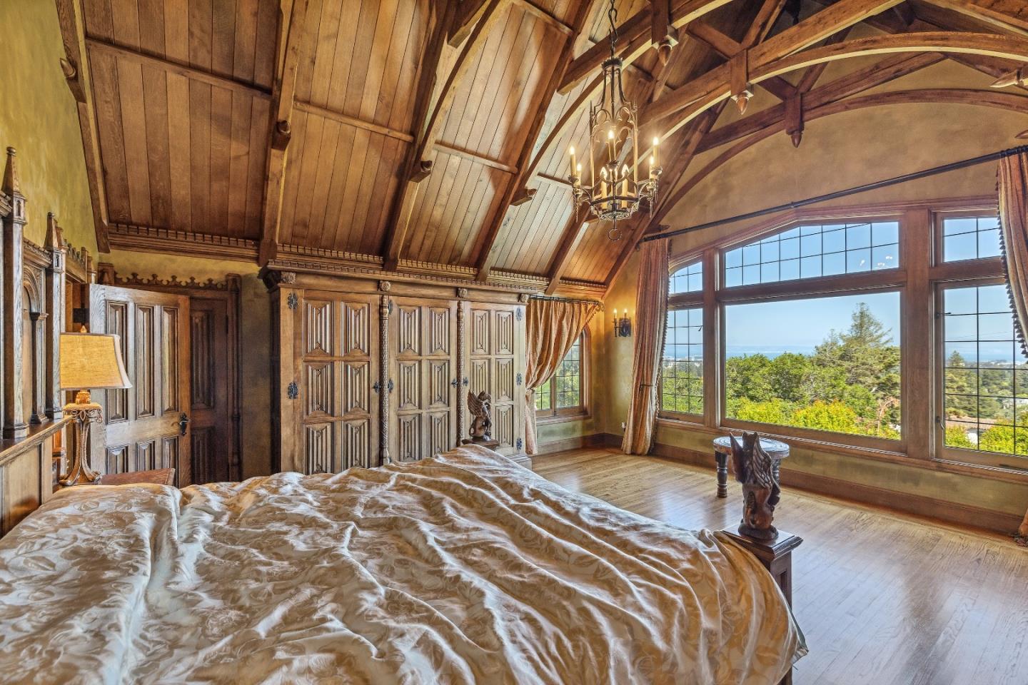 446 El Arroyo Road Hillsborough, CA 94010 - Photo 18 of 32 a bed sitting in a spacious bedroom next to a large window