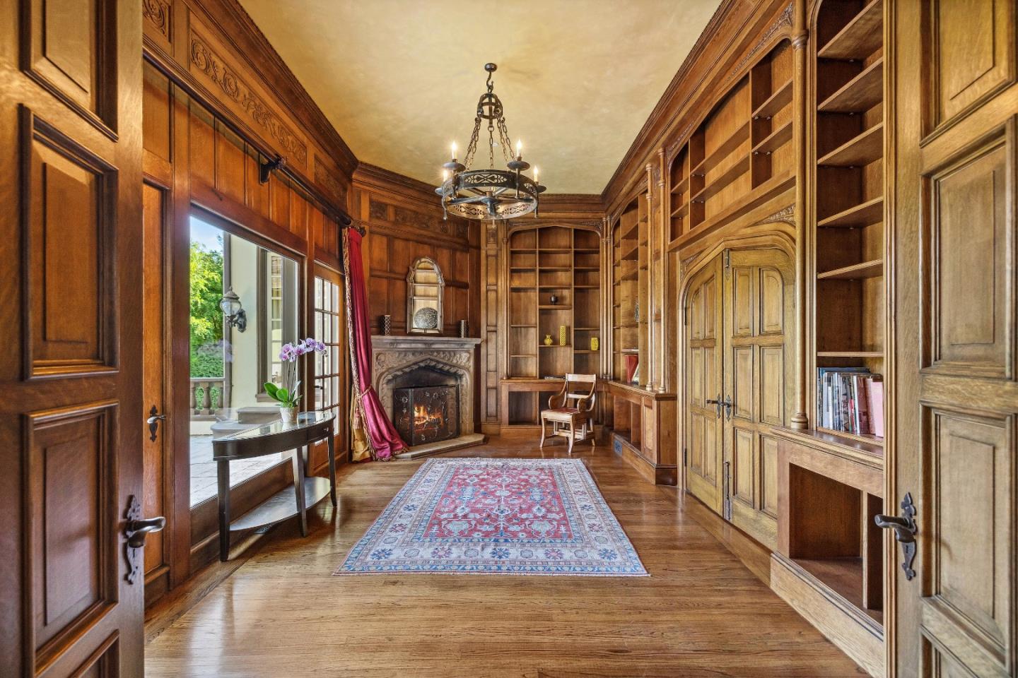 446 El Arroyo Road Hillsborough, CA 94010 - Photo 9 of 32 a living room with fireplace furniture and a chandelier