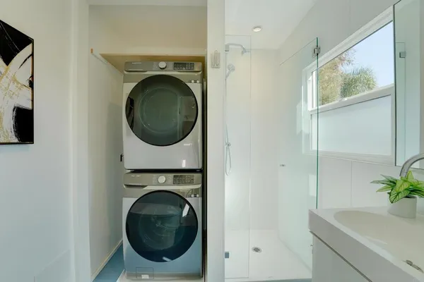 a utility room with sink dryer and washer