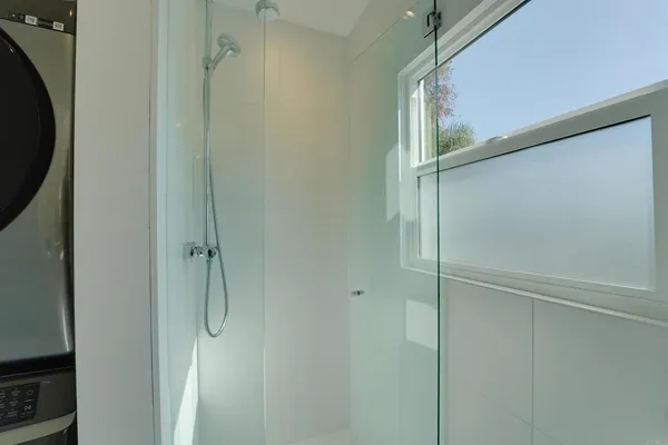 a bathroom with a glass shower door