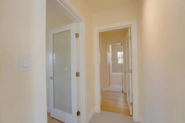 a view of a bathroom from a hallway with closet