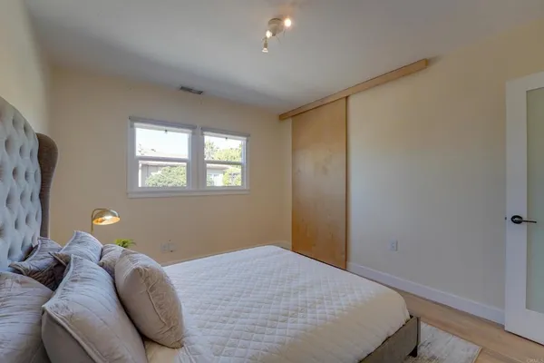 a bedroom with a bed and a window