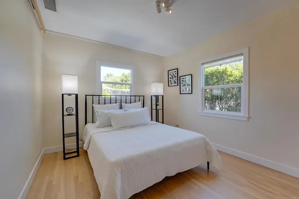 a bedroom with a large bed and a window