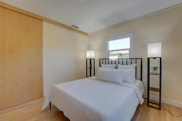 a bedroom with a bed and a night stand
