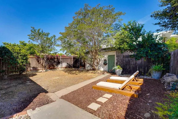 a view of a backyard with sitting area