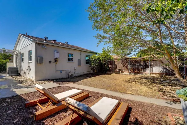 a view of a backyard with sitting area