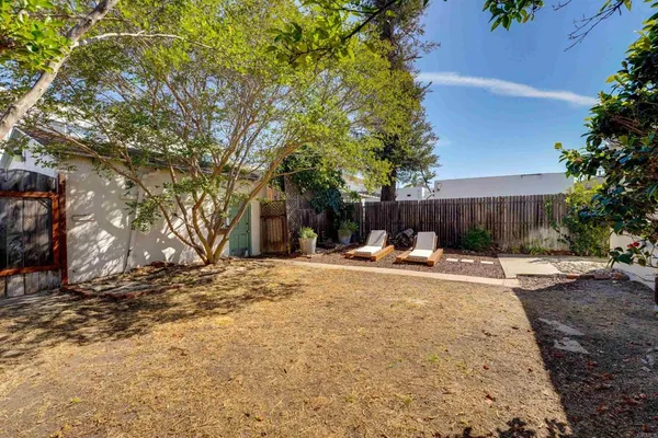 a view of a house with a yard and sitting area