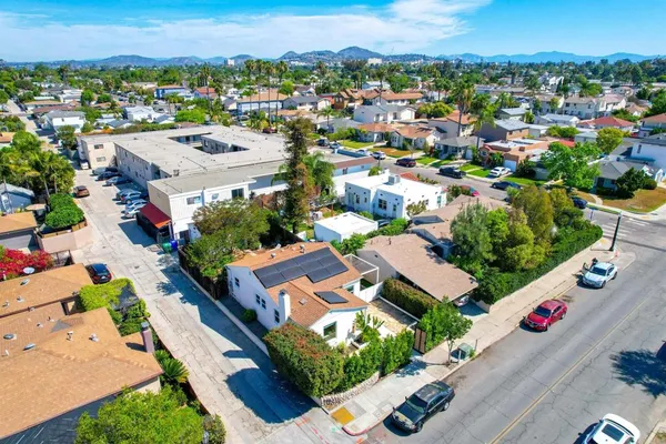 an aerial view of residential houses with outdoor space