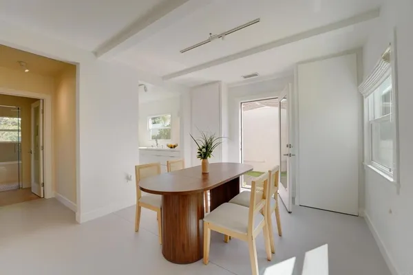 a dining room with furniture and window