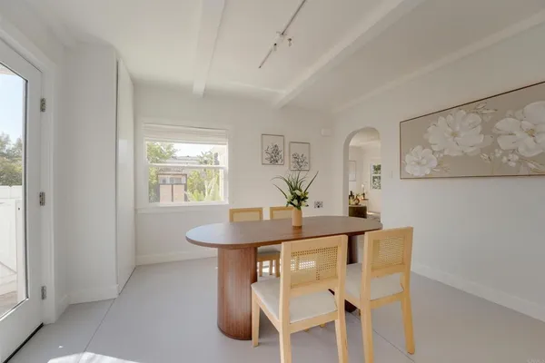 a view of a dining room with furniture and window