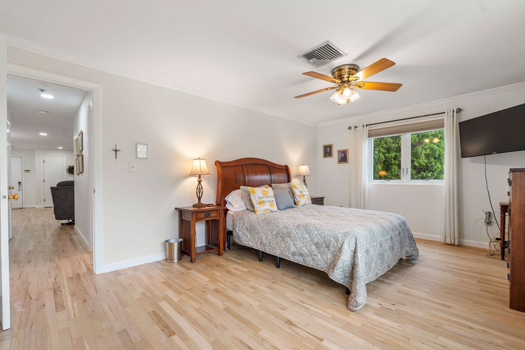 36 Dunham Road, Unit 109 Beverly, MA 01915 - Photo 12 of 22 a bedroom with a bed and a chandelier