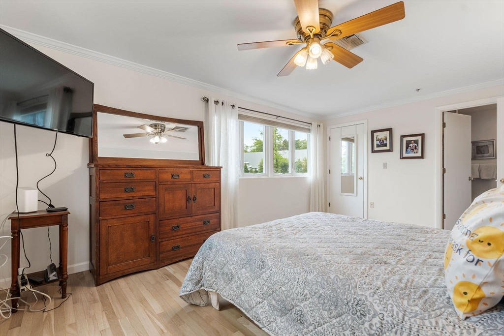 36 Dunham Road, Unit 109 Beverly, MA 01915 - Photo 13 of 22 a bedroom with a bed and a dresser in it