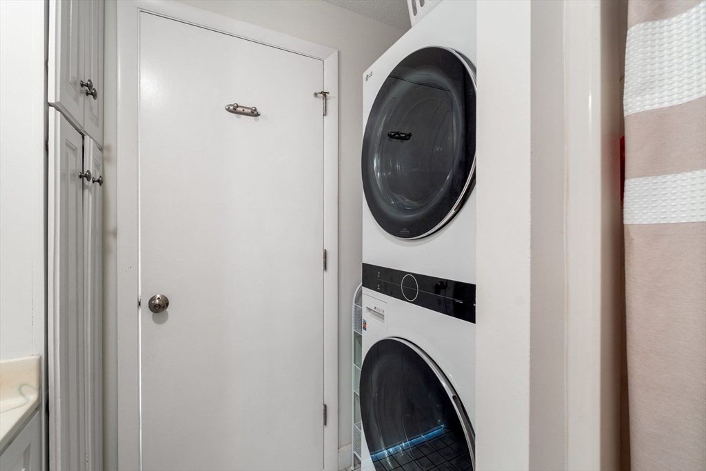 36 Dunham Road, Unit 109 Beverly, MA 01915 - Photo 15 of 22 a close view of a bedroom with washer and dryer