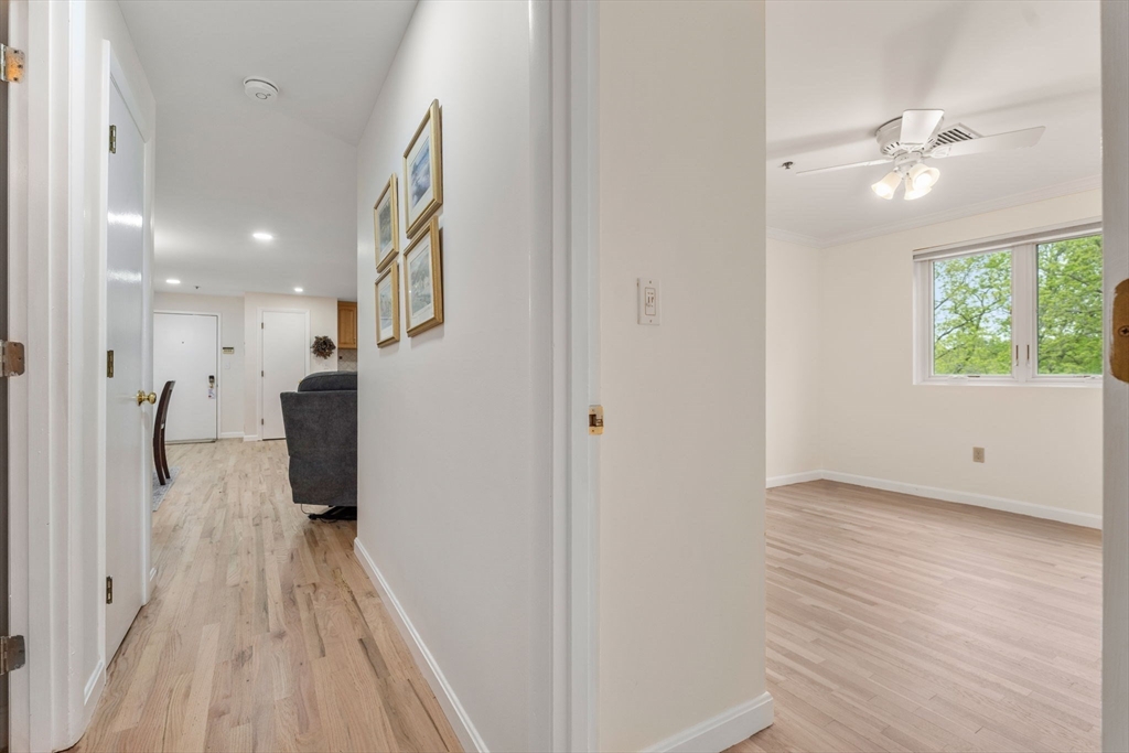 36 Dunham Road, Unit 109 Beverly, MA 01915 - Photo 16 of 22 a view of a hallway view with wooden floor and staircase