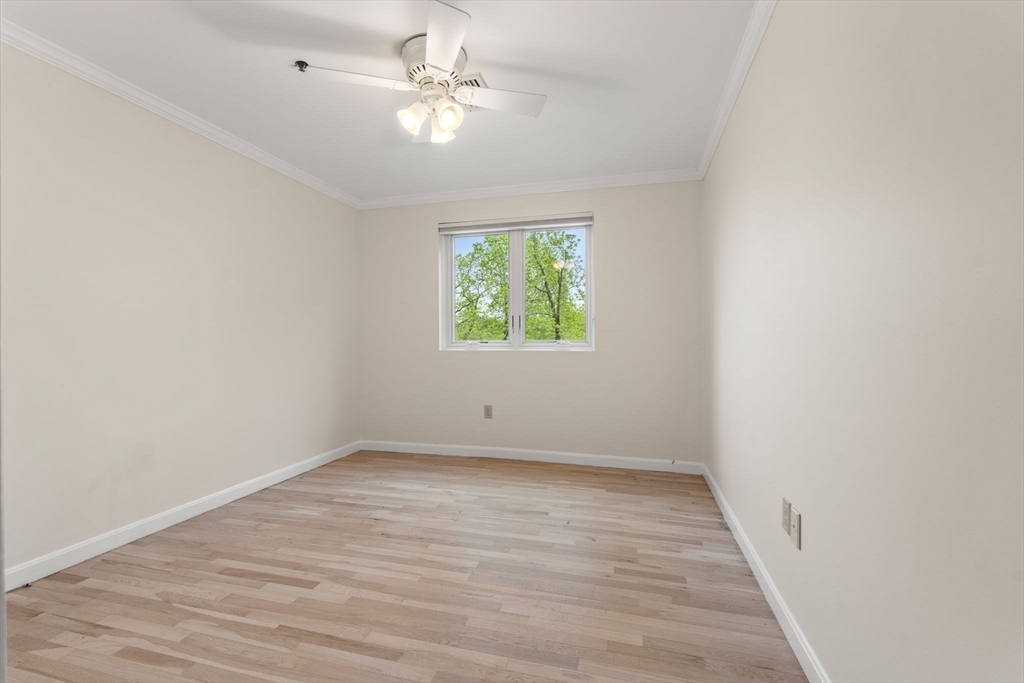 36 Dunham Road, Unit 109 Beverly, MA 01915 - Photo 17 of 22 wooden floor in an empty room with a window