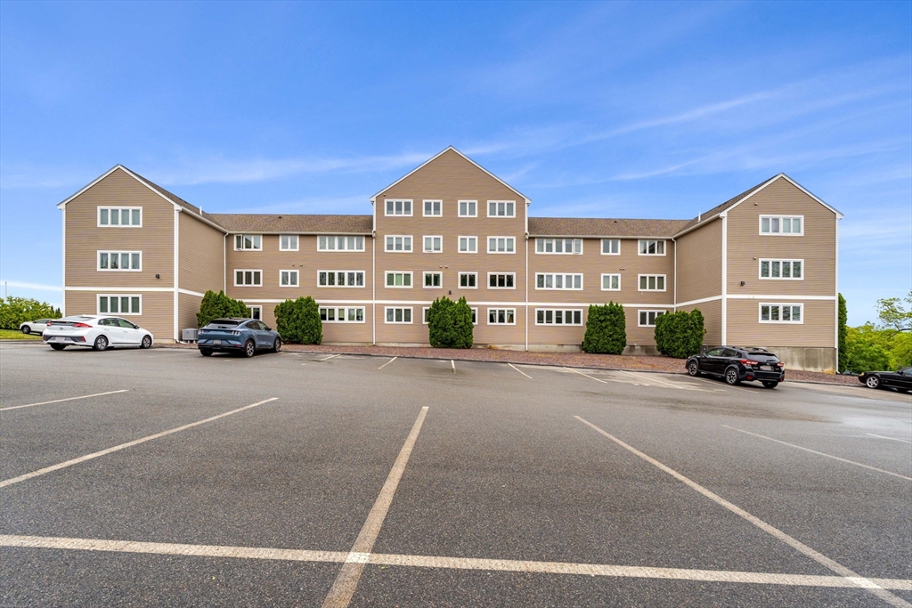 36 Dunham Road, Unit 109 Beverly, MA 01915 - Photo 21 of 22 a view of a street with a building in the background